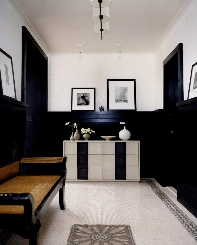 Bathroom with mosaic tile floor and black half paneled walls