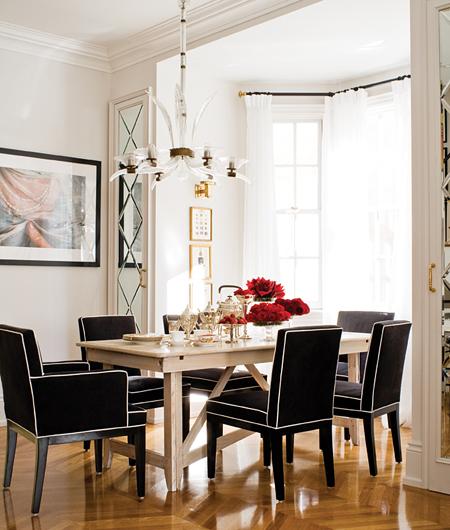 Dining room with balck upholstered dining chair with white piping