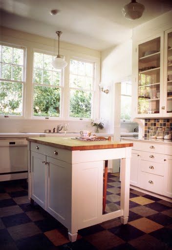Retro kitchen with linoleum floors and a tile backsplash to match by Kevin Oreck
