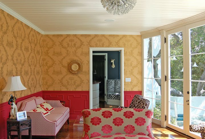 Sitting room in a remodled and restored Regency home by Kevin Oreck with pink wainscoting and peach brocade wallpaper, beadboard ceiling, pink sofa with red piping and a white and pink floral love seat