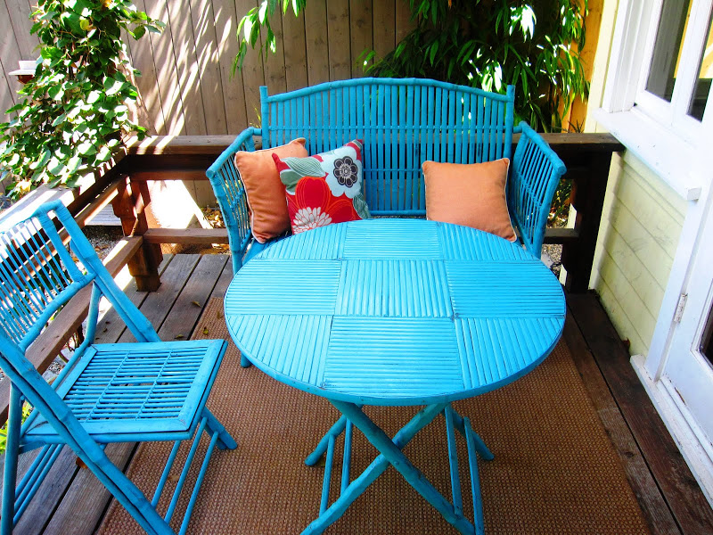 Turquoise blue rattan dining set on a deck in Venice Beach, CA