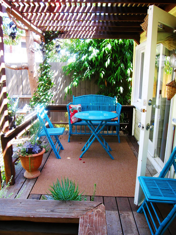 Turquoise blue rattan dining set on a deck in Venice Beach, CA