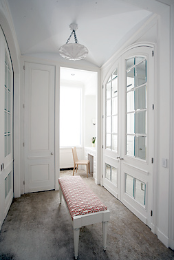 White and grey dressing room by Peter Pennoyer with custom made closet cabinetry with mirrored doors