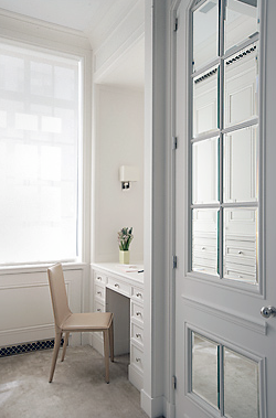 Built in desk in a grey and white dressing room by Peter Pennoyer